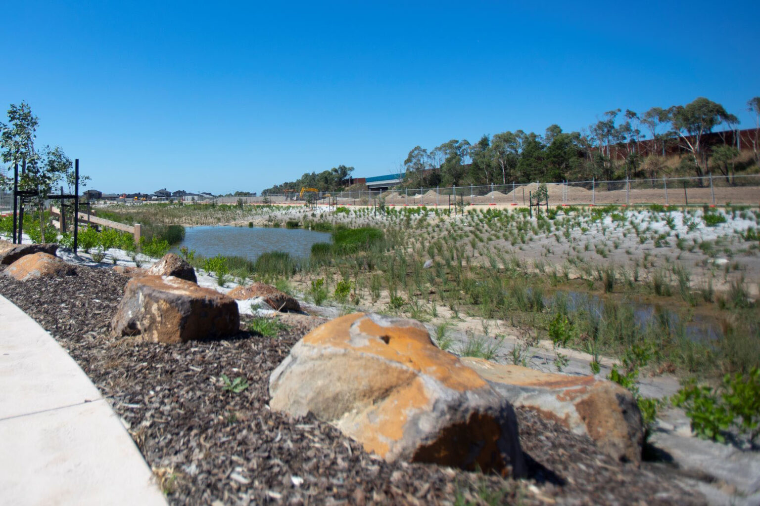 Waterway, pedestrian pathways and construction works at Arcadia estate in Officer.