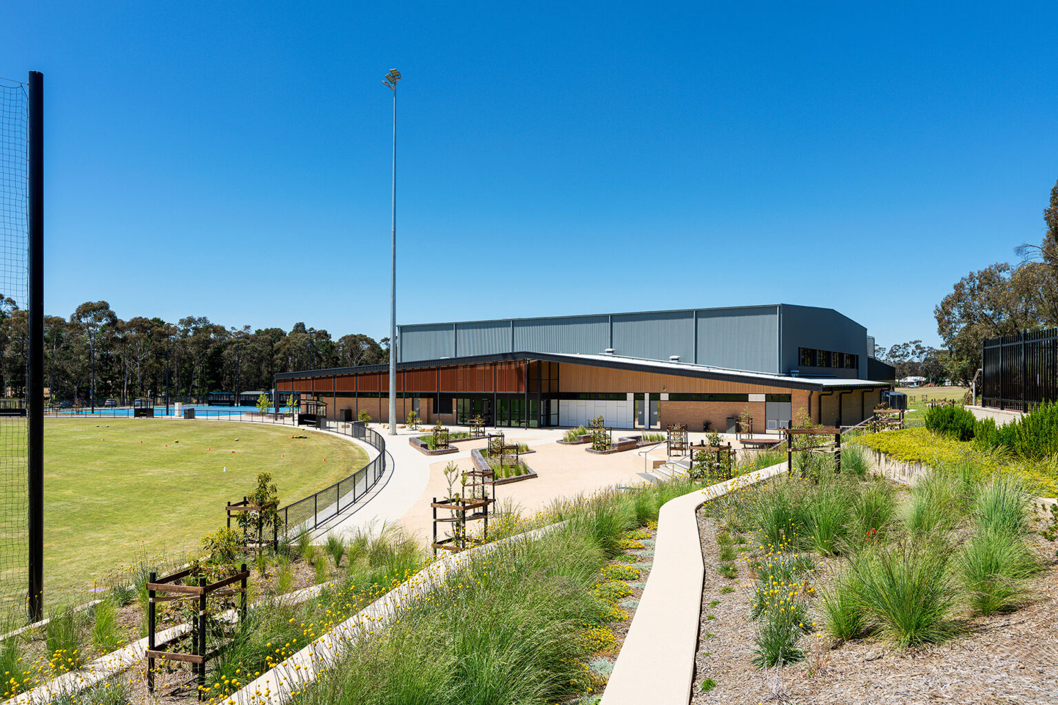 Sporting field, school building and planting at the Mercy Junortoun Sporting Precinct in Bendigo.