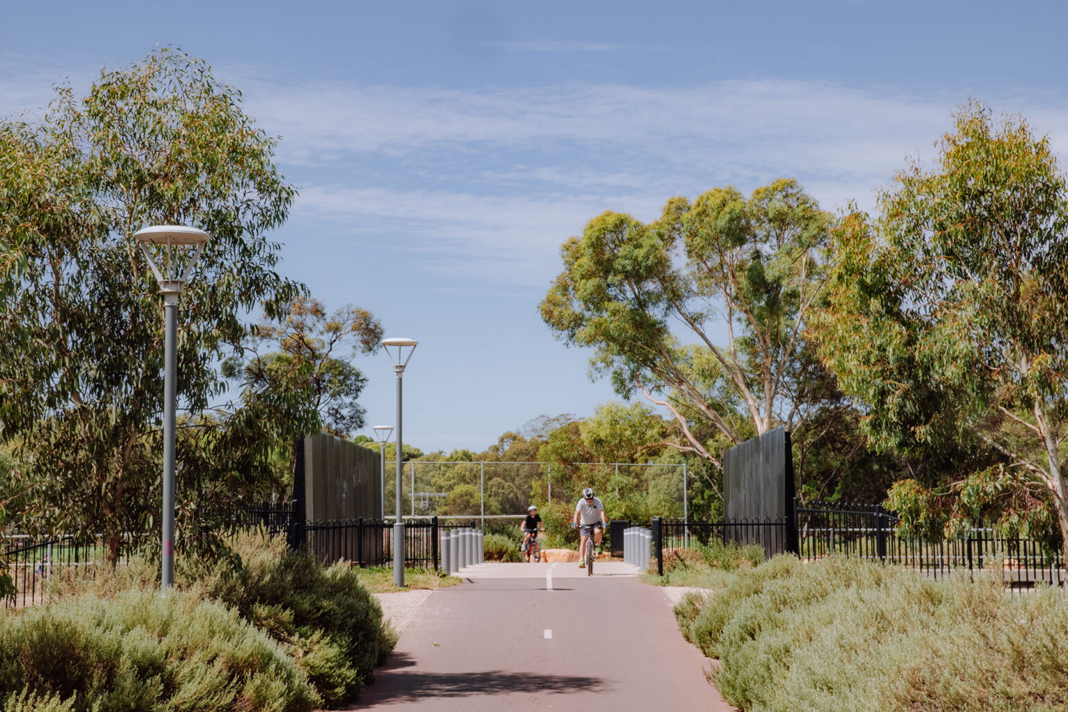 wo people riding bikes at Torrens Junction designed by Spiire landscape Architects